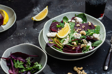 Salad with beets and goat cheese on a dark background