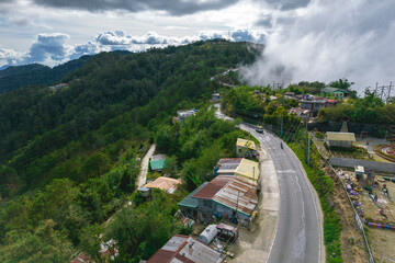 Fototapeta na wymiar Aerial of Halsema Highway in Atok, Benguet. Fog encroaching into the top of the ridge.