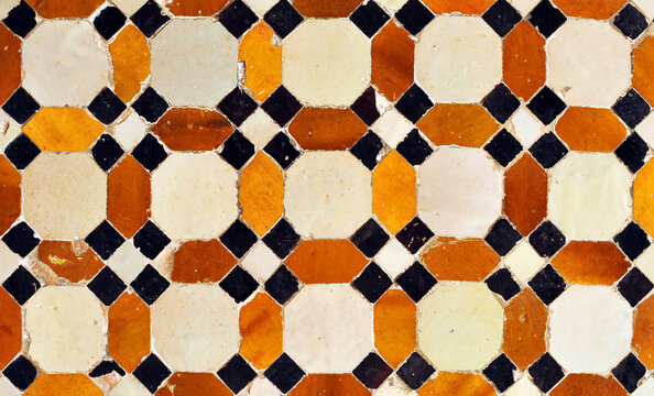 Arab geometric mosaic of the Alhambra in Granada. Al Andalus tiles called alicatados. Arabic tiles from Spain. Alhambra Palace in Granada, a UNESCO World Heritage Site