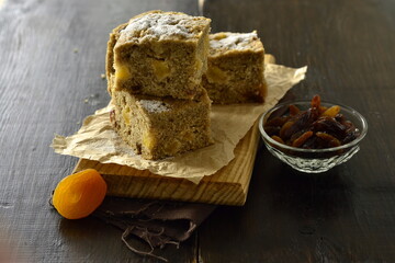 Cake with dried fruits on a wooden board
