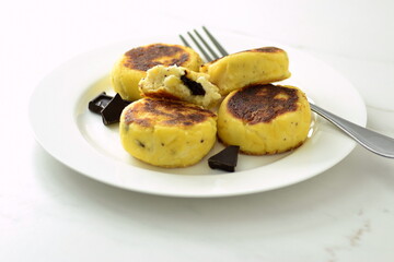 Syrniki, cottage cheese fritters with chocolate, minimalist style