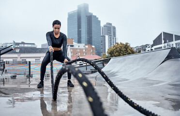 Fitness, workout and black woman with rope in city for cardio exercise, bodybuilder training and...