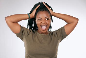 Comic, funny and black woman with a crazy face isolated on a grey studio background. Smile, happy and African girl model with tongue sticking out for comedy, happiness and goofy on a backdrop