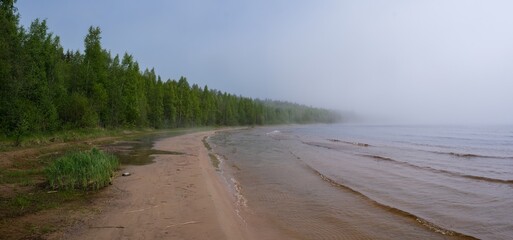 foggy landscape of lake ladoga sand shore