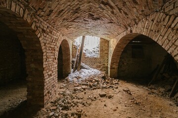 abandoned basement with arched red brick ceilings