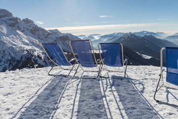 Sunbeds with a view of the Pinzolo valley. Inversion and fog over the ski area of Pinzolo (TN)...