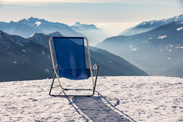 Sunbeds with a view of the Pinzolo valley. Inversion and fog over the ski area of Pinzolo (TN)...