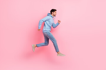 Fototapeta na wymiar Full length profile side photo of optimistic stylish man moving empty space hurry buy low prices clothes isolated on pink color background