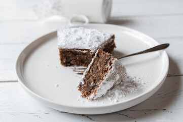 Torta caprese, italian chocolate, almond cake on a white plate