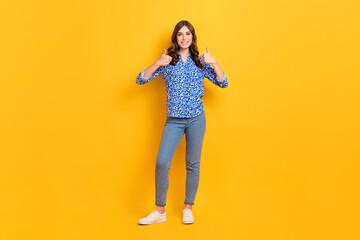 Fototapeta na wymiar Full length portrait of gorgeous positive person hands fingers demonstrate thumb up approval isolated on yellow color background