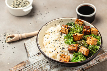 Savory sauteed mixed chinese rice, broccoli with fried tofu. Healthy food concept. place for text, top view