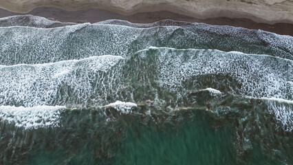 Aerial Top View Drone Footage Of Ocean Waves Reaching Shore
