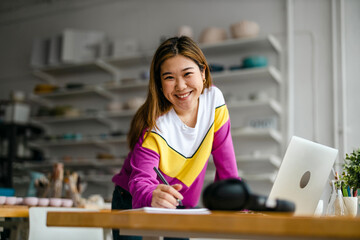 Young female freelancer working in loft office
