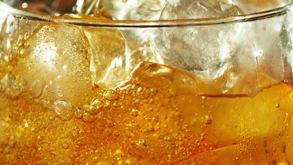 Detail of cider with ice cubes in glass.