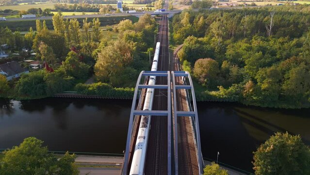 german ice train run over Railway river bridge. Perfect aerial view flight drone