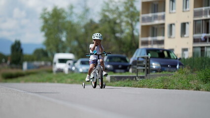 Obraz premium One tearful cyclist child covering face feeling sad. Small boy wearing helmet on bike outside crying