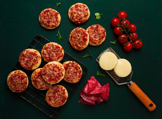 Mini pizzas, salami with mozzarella cheese, on the table, top view, no people,