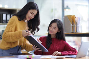 Happy businesswomen colleagues discussing in the office, Planning collaboration and participation of people in the organization.