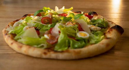 Juicy, fragrant delicious pizza on the table on a sunny day