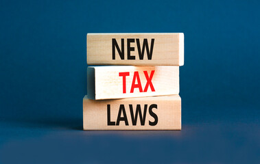 New tax laws symbol. Concept words New tax laws on wooden blocks on a beautiful grey table grey background. Business new tax laws concept. Copy space.