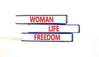 Woman life freedom symbol. Concept words Woman Life Freedom on books on a beautiful white table white background. Social issue woman life freedom concept. Copy space.