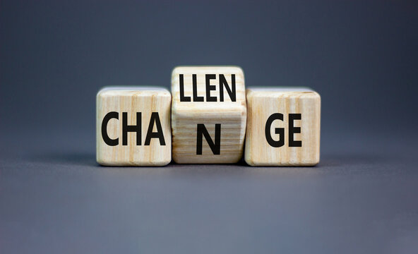 Challenge and change symbol. Concept word Challenge Change on wooden cubes. Beautiful grey table grey background. Business and challenge and change concept. Copy space.