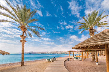 Early morning on sandy beach at the Red Sea near Eilat - famous tourist resort and recreation city in Israel