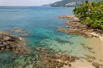 Kalim Beach, Phuket, Thailand - January 28, 2023: Tourists at Kalim beach are chilling and snorkelling