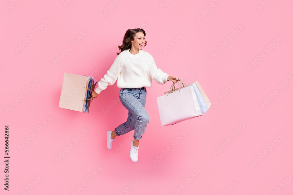 Canvas Prints Full length photo of sweet impressed woman dressed pullover jumping holding bargains empty space isolated pink color background