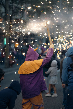Crowd of people with burning sparklers on festival