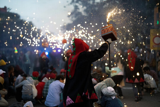 Crowd of people with burning sparklers on festival