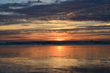 sunset under the clouds by the sea