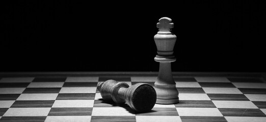 chess game chess figures on an old wooden table, black background  copy space,
 the hand of a...