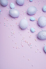 Bunch of colorful eggs with dots on purple background. Minimal Easter concept with copy space for text.