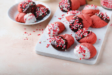 Valentines day cookies. Shortbread cookies with glaze white and dark chocolate and heart sprinkles on plate on white background. Mothers day. Womans day. Sweet holidays baking. Top view.