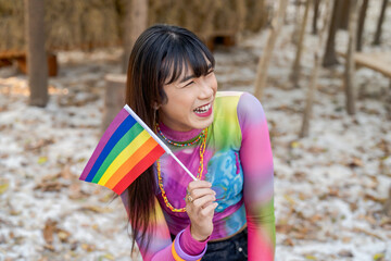 Gender Spectrum smiling happy Thai transgender woman with rainbow flag