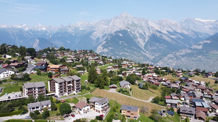 Fototapeta na wymiar Swiss Alps in Sion region, aerial footage taken by a drone during warm summer time, clear blue skies and beautiful mountain scenery