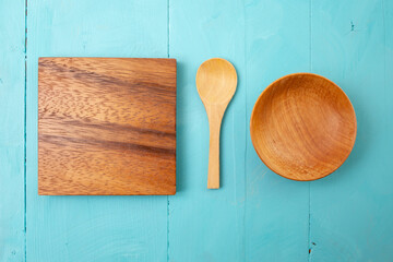 wooden little spoon, square chopping board, and bowl