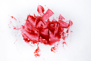 Red paint like blood smudged on white paper