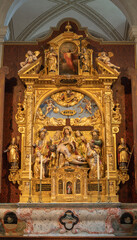 Fototapeta na wymiar LUZERN, SWITZERLAND - JUNY 24, 2022: The carved polychrome side altar with the Pieta (Deposition) in the church St. Leodegar im Hof by Niklaus Geisler (1585-1665)
