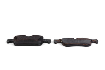 New сar brake pads compared to old used brake pads on white background.