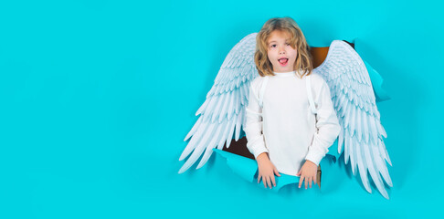 Valentine banner. Cute kid boy in angel costume, white dress and feather wings. Innocent child.