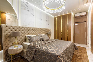 luxury hotel bedroom. Bed with carriage coupler headboard