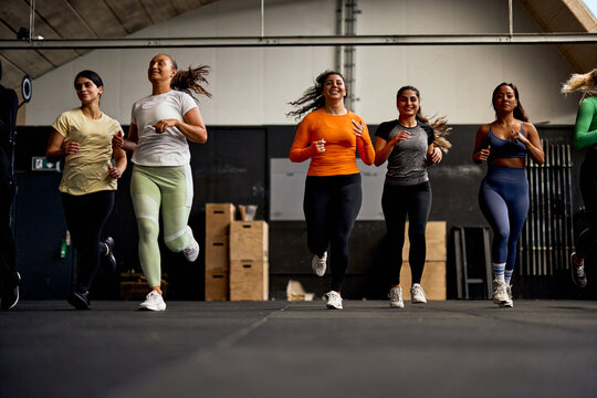 Smiling women running in a gym