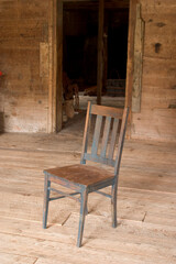 Fototapeta na wymiar Old wooden chair in a barn in Isle LaMottr, Vermont, USA