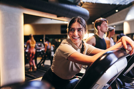 Woman Smiling On A Gym Treadmill