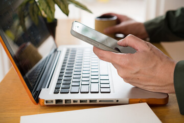 Close up hand of technology in use . Businessman typing on laptop at workplace , Man working in home office hand keyboard.. Concept of using technology in communication.