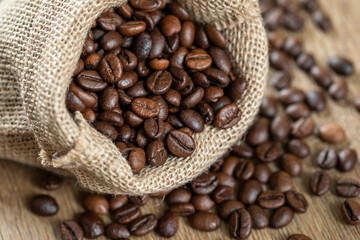 Roasted coffee beans close-up on a burlap background, texture. Good mood. Coffee aroma. Selective focus