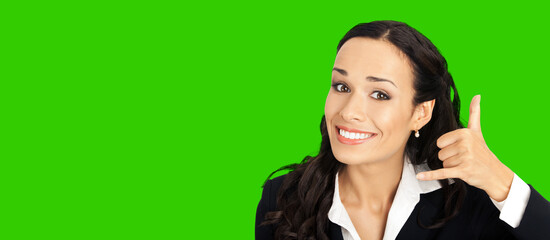 Young happy smiling business woman with call me gesture. Green chroma key background.