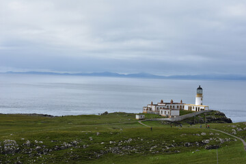 Fototapeta na wymiar landscape of Neist Point Lighthouse isle of Skye , The white lighthouse on edge of cliff ,coastal lighthouse